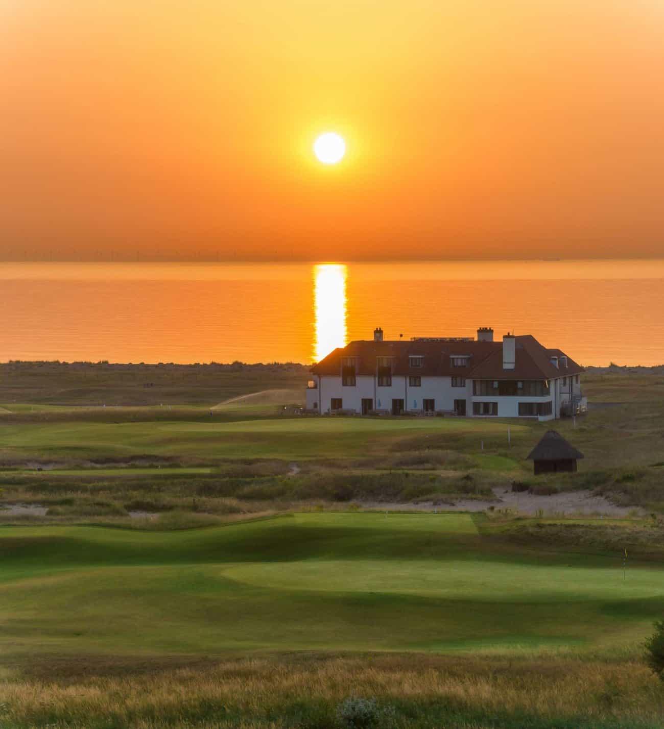 Panoramic view of the sun setting over Prince's Golf Club