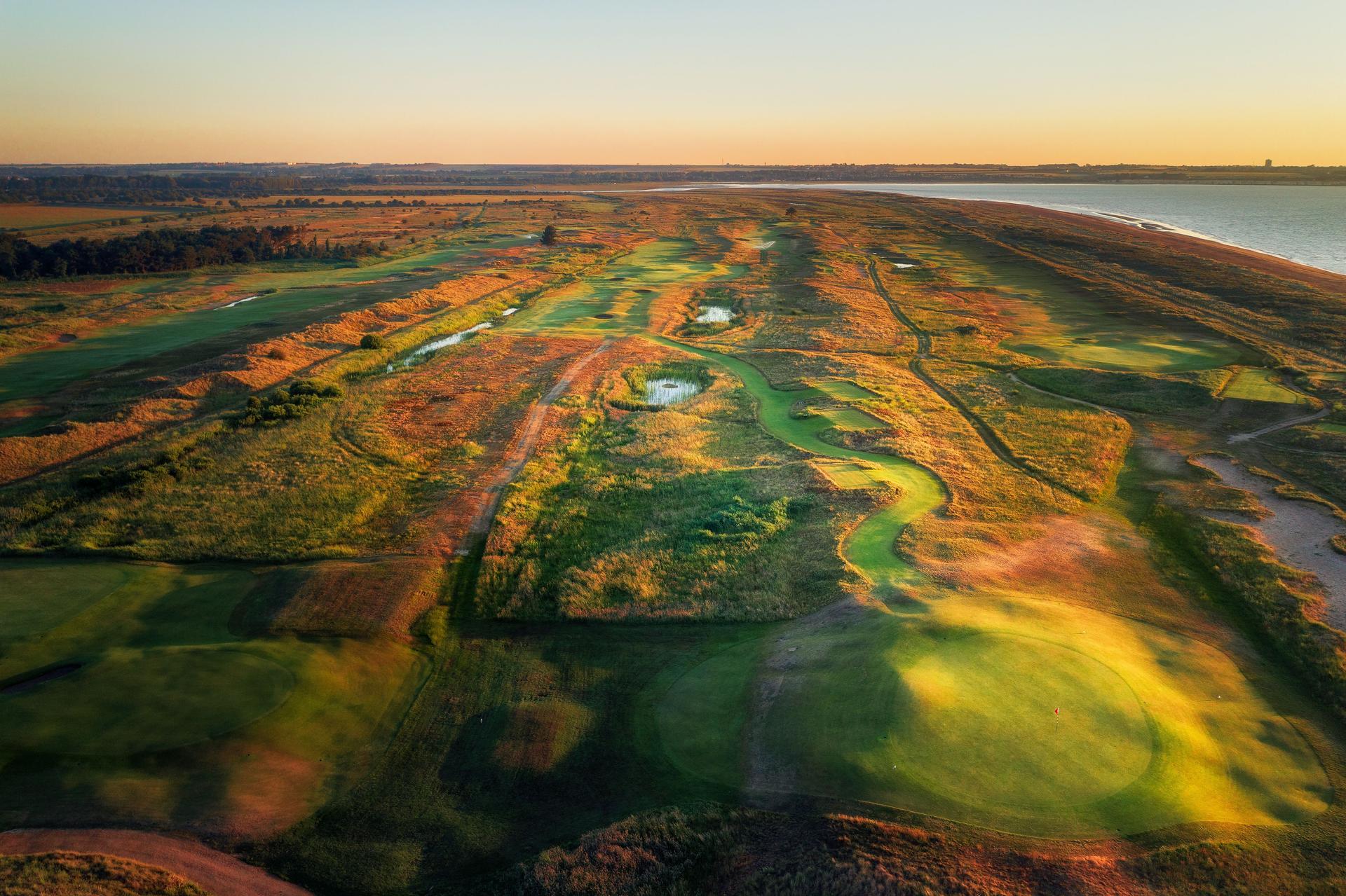 Overhead view of a well maintained fairway nestled with sand bunkers