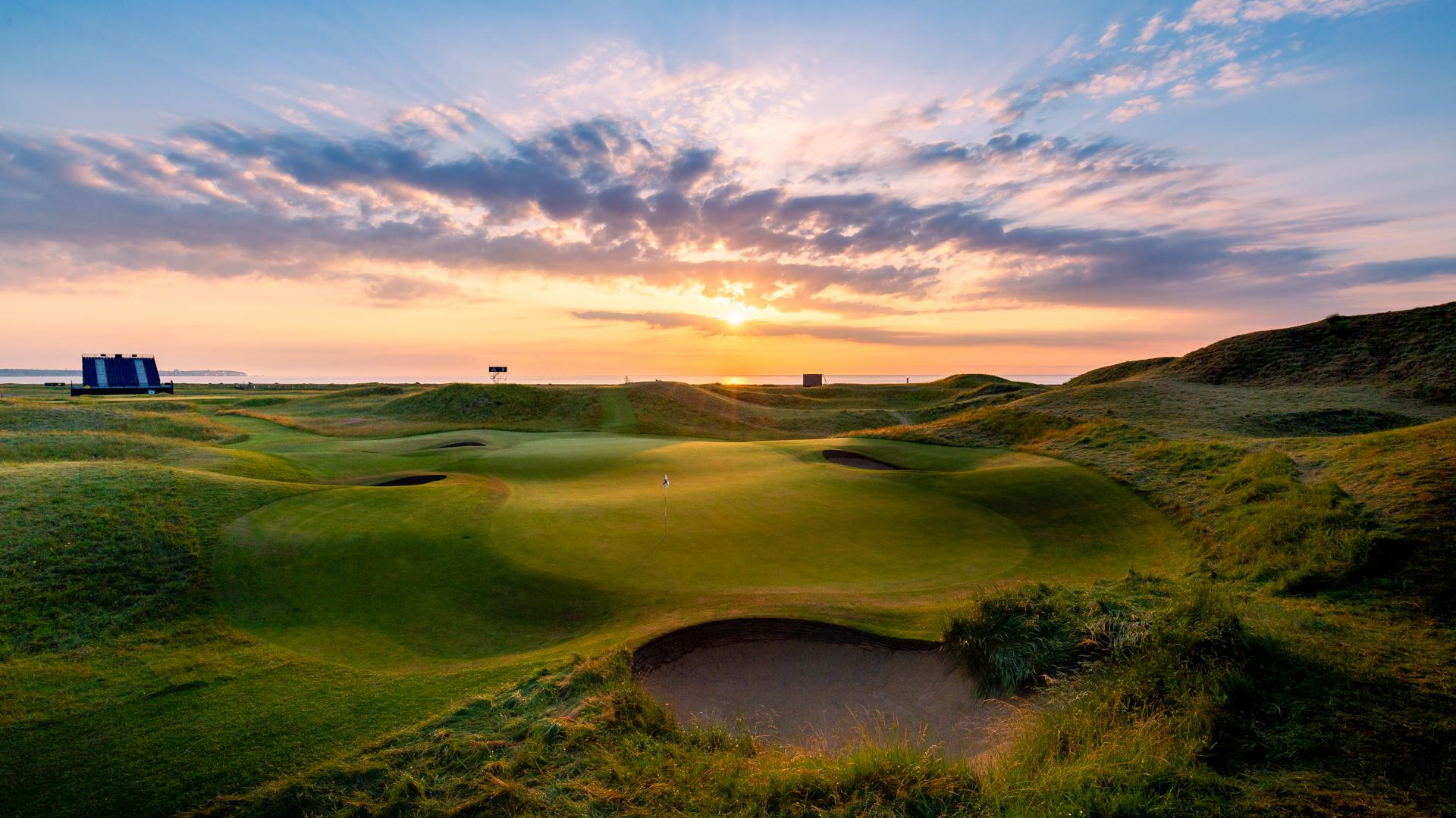 A smooth green next to a sand bunker at Royal St George's Golf Club