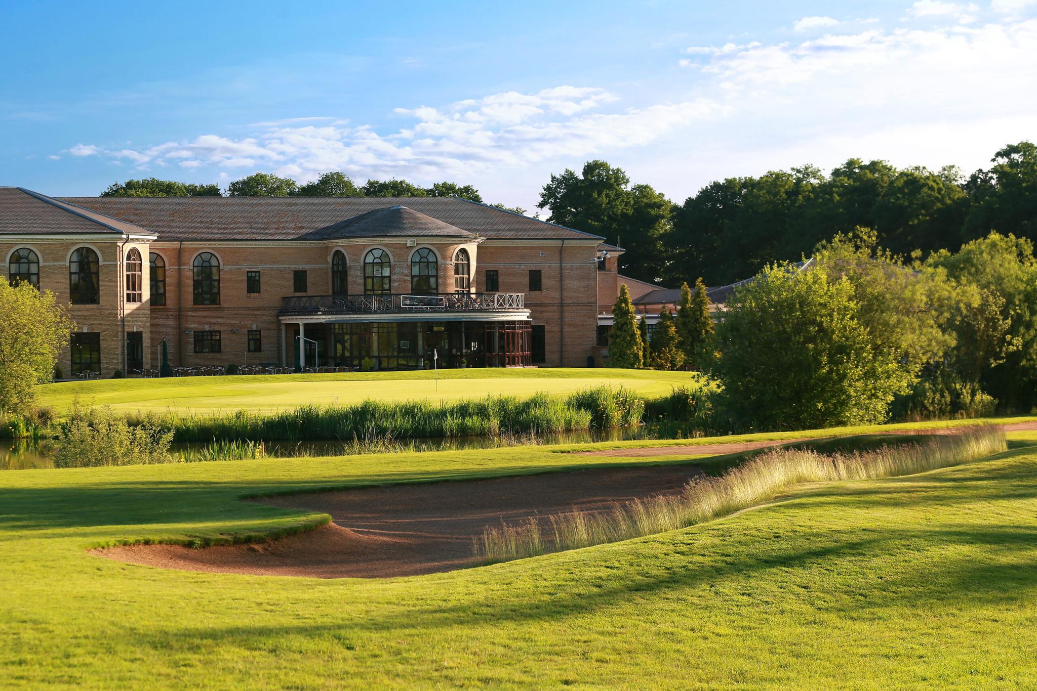 A well maintained fairway with with a deep sand bunker