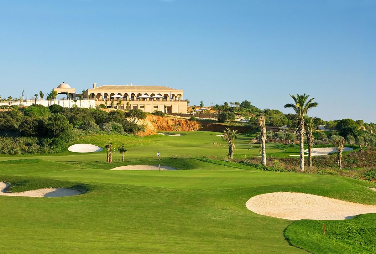 A well maintained fairway nestled with sand bunkers