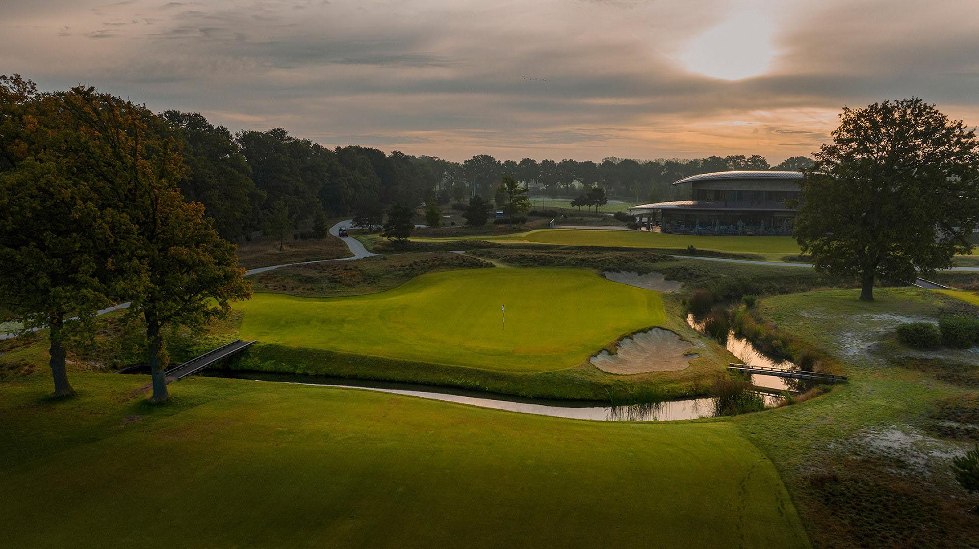A manicured fairway split up by a water hazard