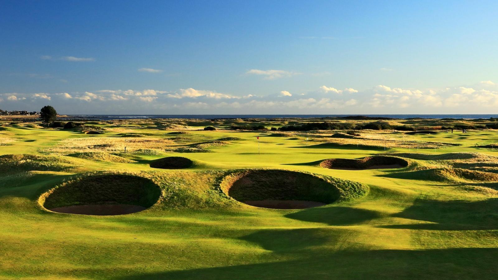 A well maintained fairway littered with sand bunkers at the Carnoustie Golf Resort Scotland
