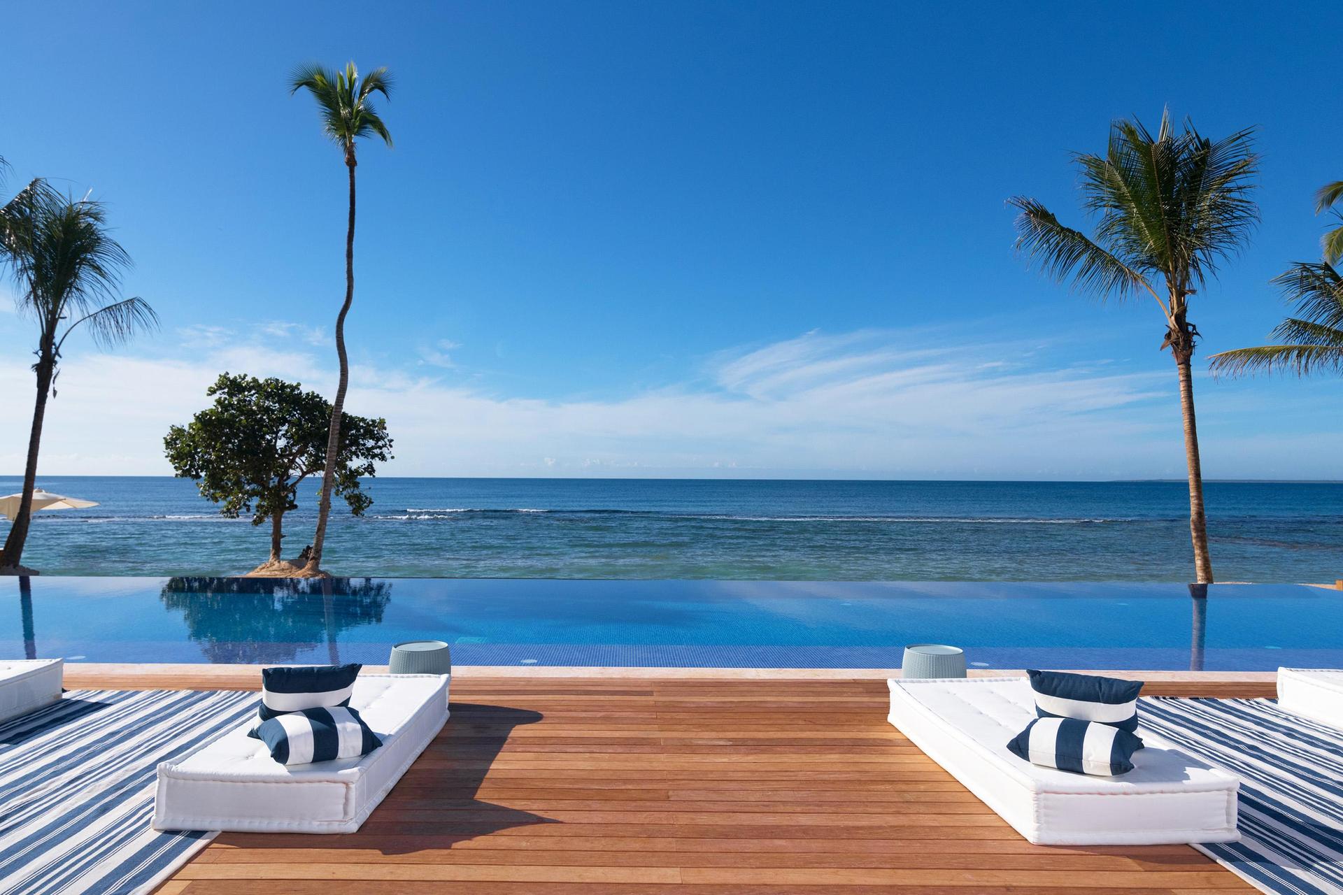 Ocean front facing sunbeds with palm tree views
