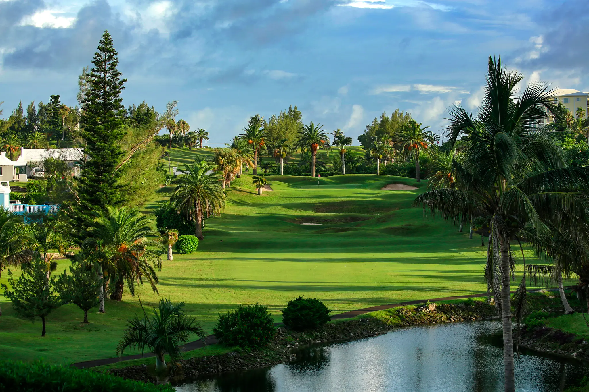 A well maintained fairway nestled with sand bunkers