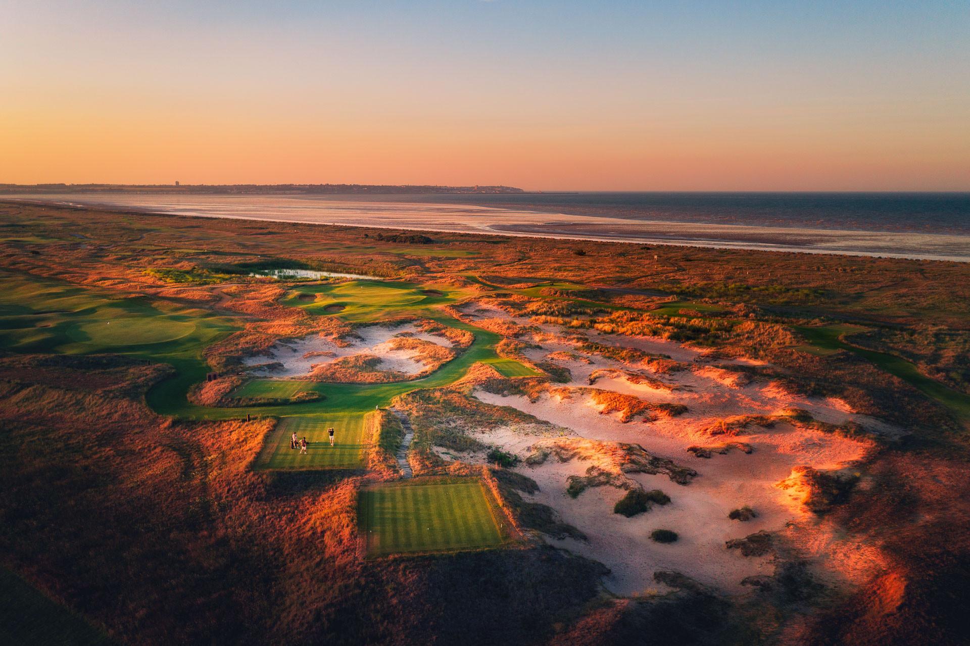 Overhead view of a winding fairway nestled with sand bunkers