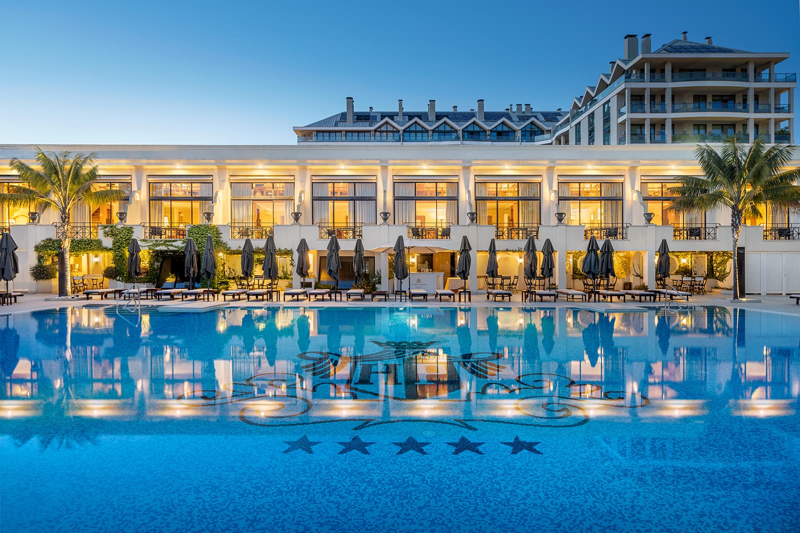 Panoramic view of the Palacio Estoril Golf & Spa Hotel building overlooking the outdoor pool
