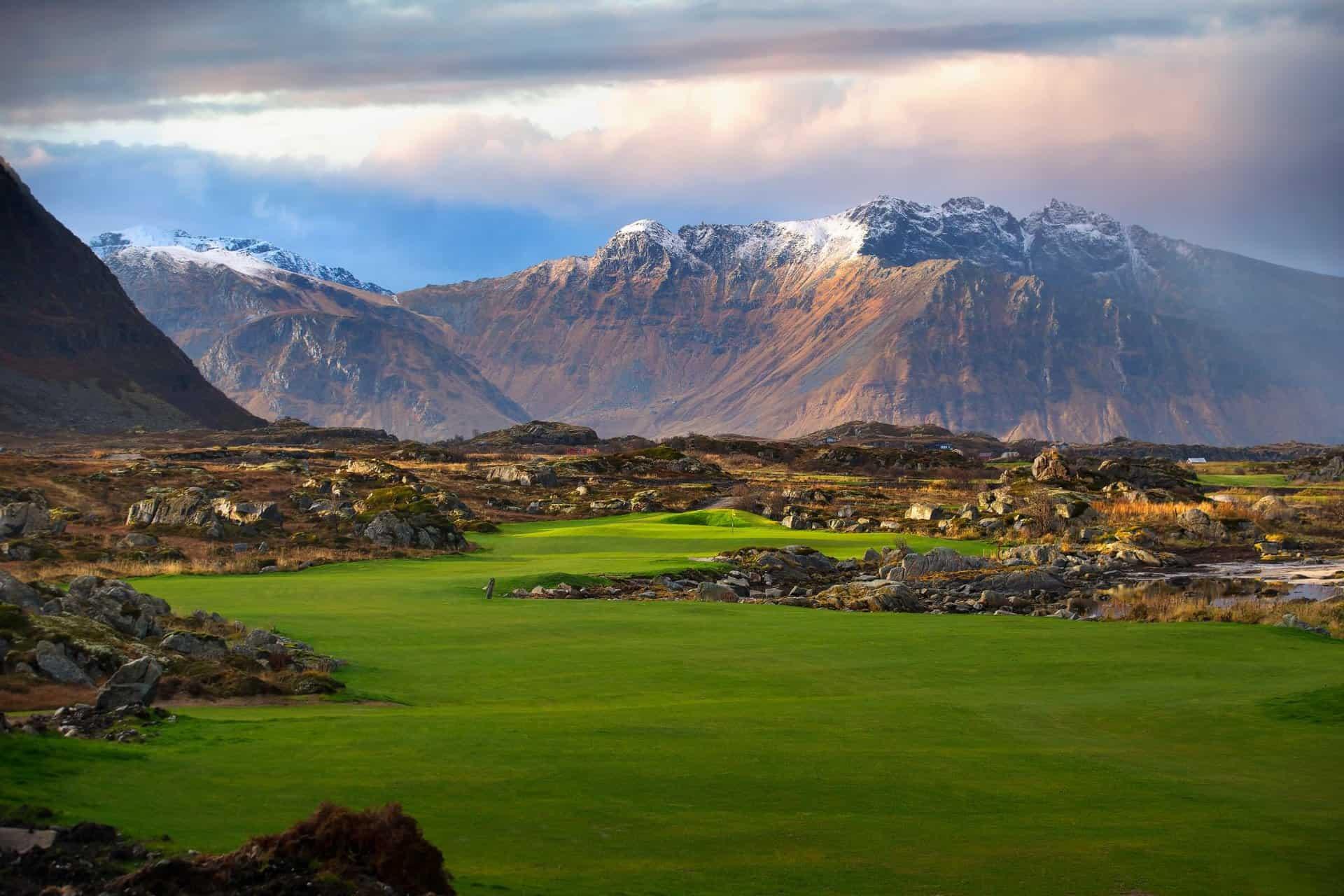 A well maintained winding fairway with distant mountain views