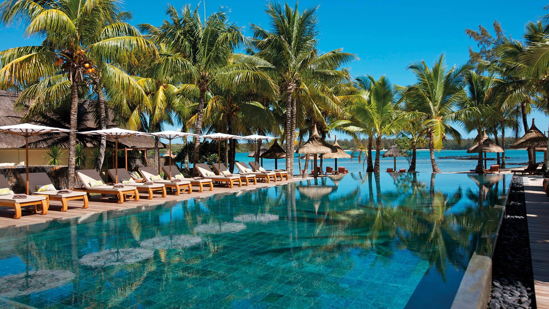 Outdoor swimming pool surrounded by sunbeds