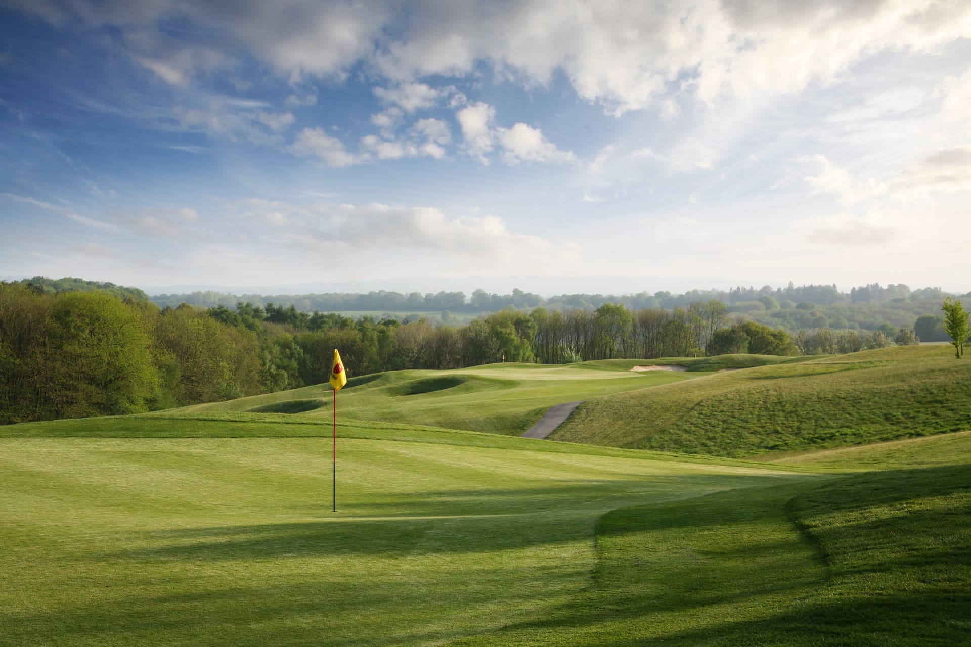 Smooth, manicured green with a steep drop behind
