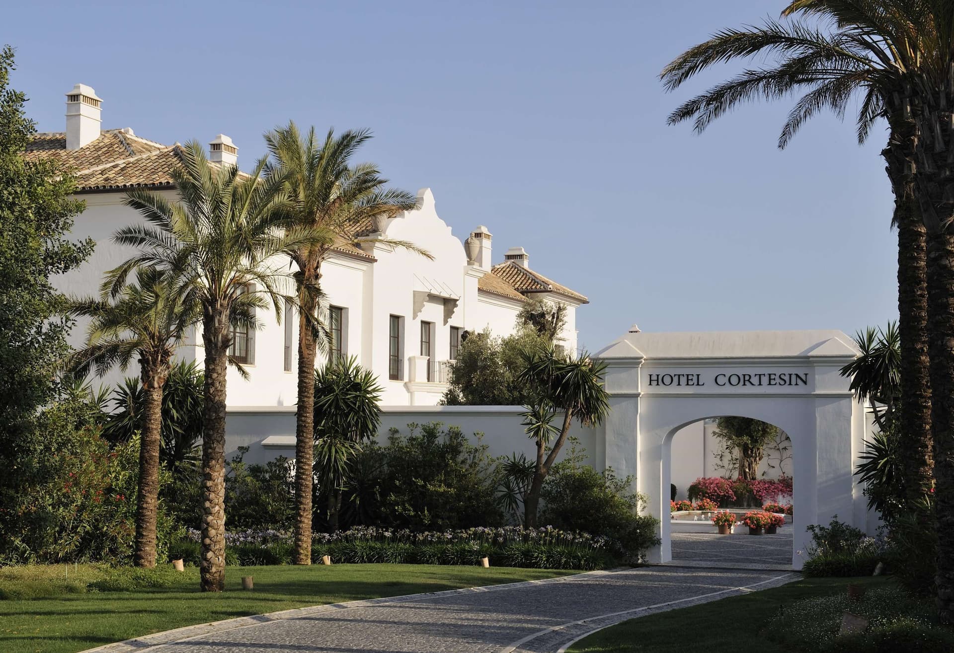 Front entrance to the Finca Cortesin Hotel lined with palm trees