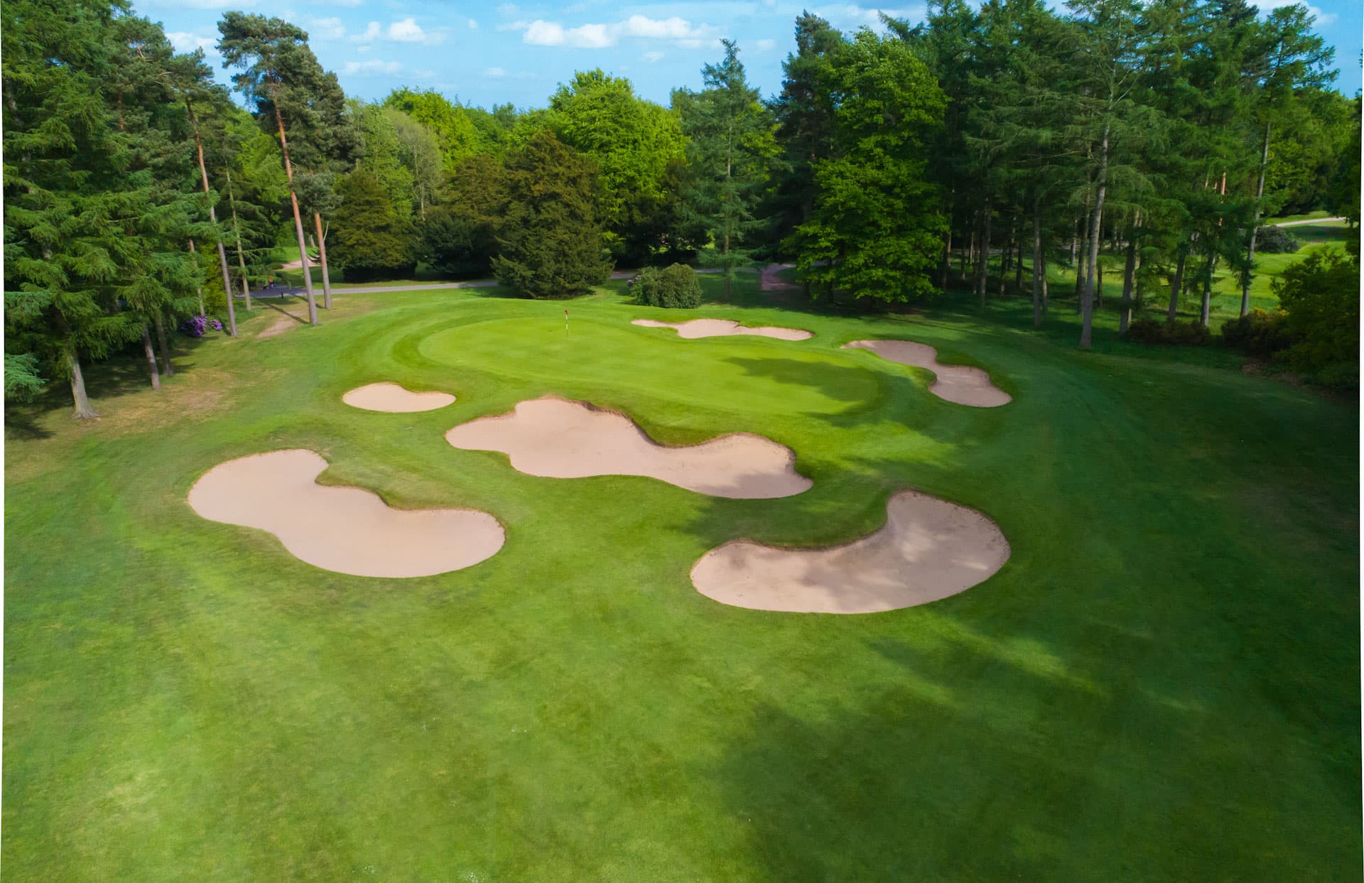 A smooth green surrounded by sand bunkers