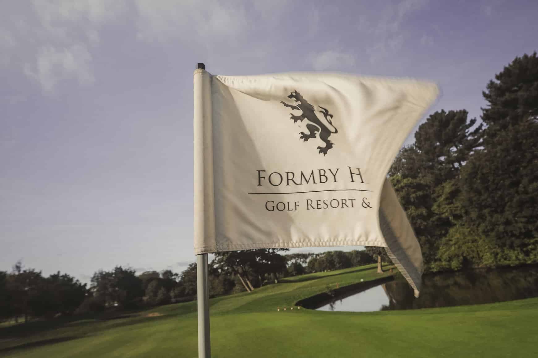 Flagstick at the golf club with the Formby Hall Golf Resort & Spa logo