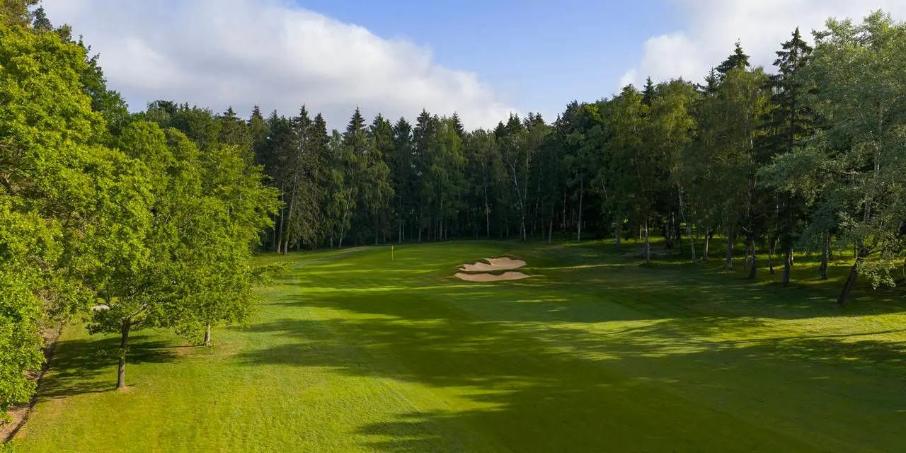 A well maintained fairway with a sand bunker