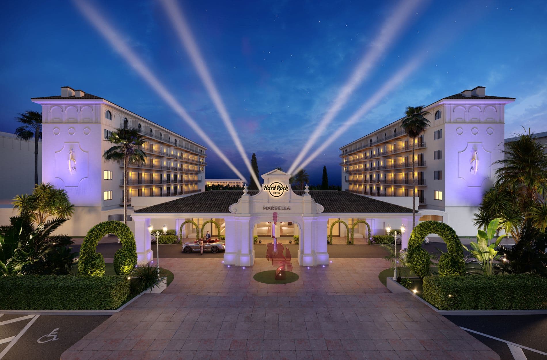 Front entrance to the hotel at night with spotlights behind