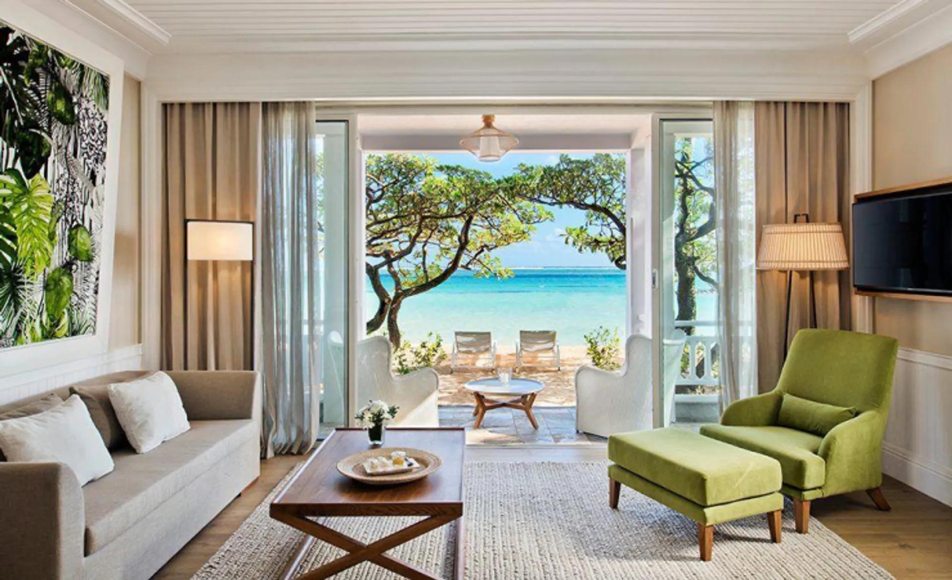 Lounging area as part of a suite with a patio space leading out to the beach