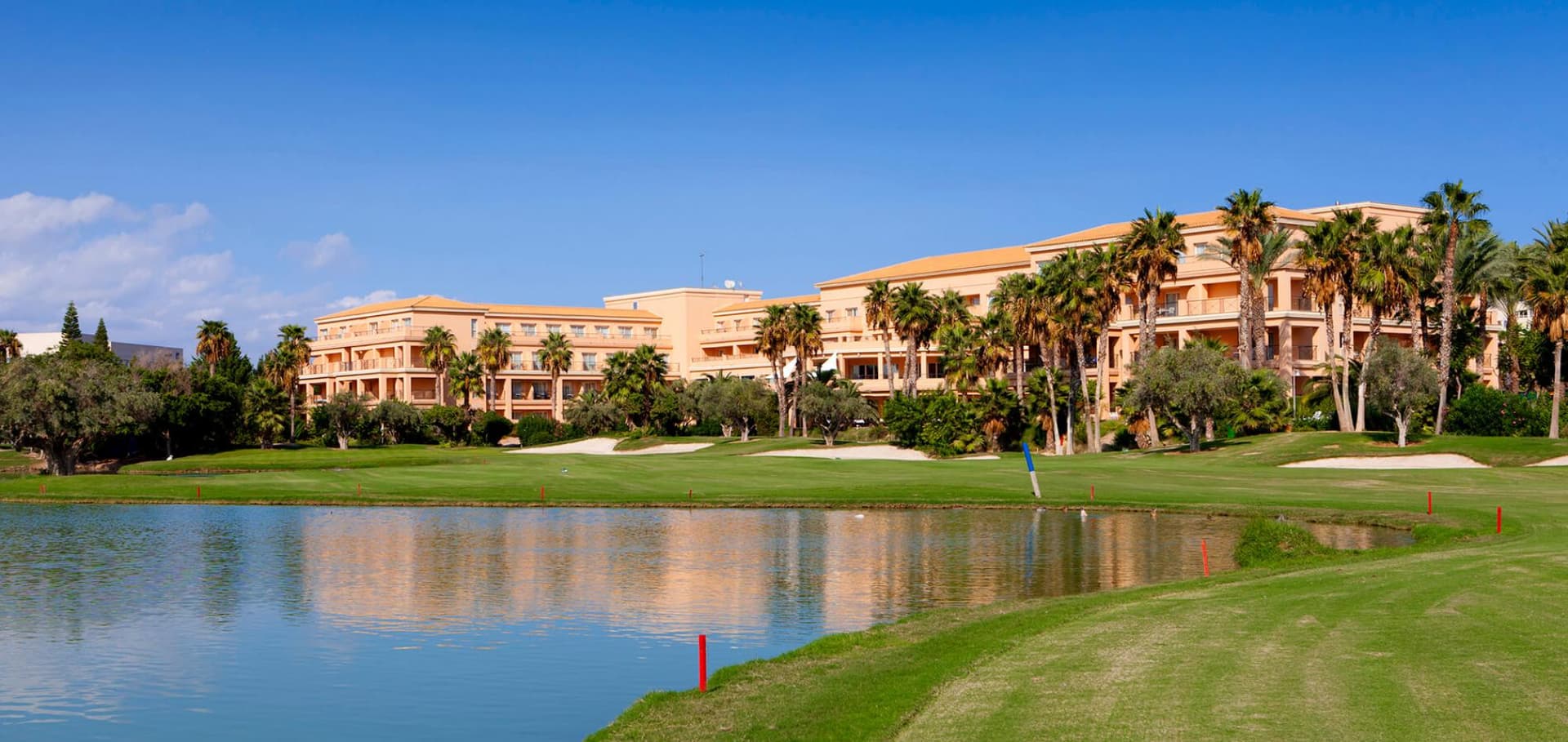 A well maintained fairway running next to a water hazard