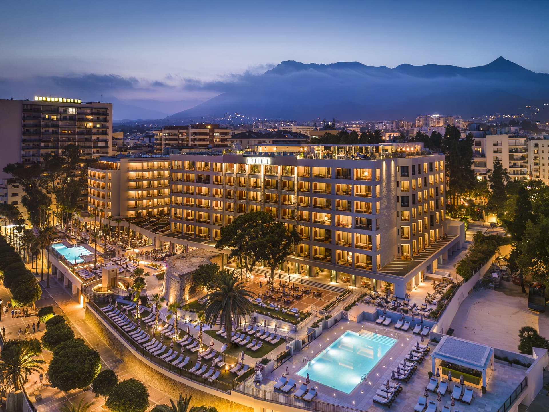 Panoramic view of the Hotel El Fuerte Marbella lit up at night