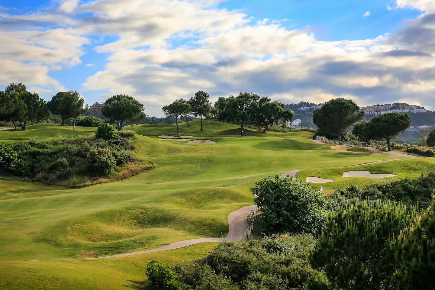A well maintained fairway under cloudy skies at La Cala Golf Resort - Rentals