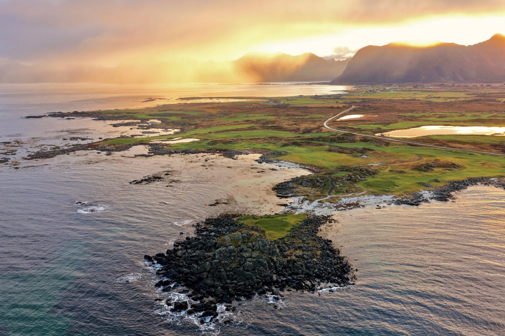 Overhead view of the sun setting in the distance over the Lofoten Links course