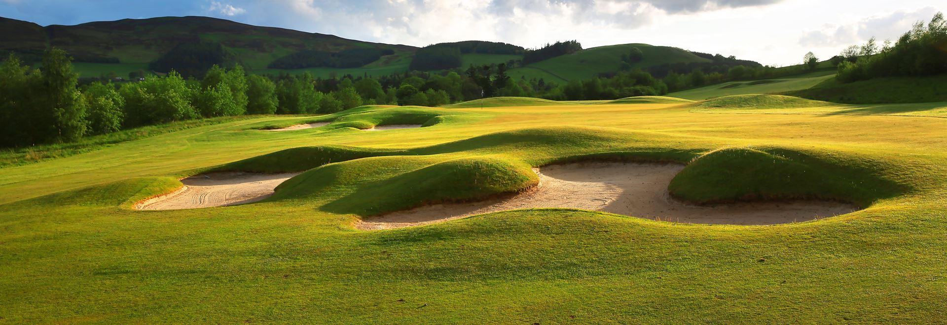 A well maintained fairway nestled with sand bunkers