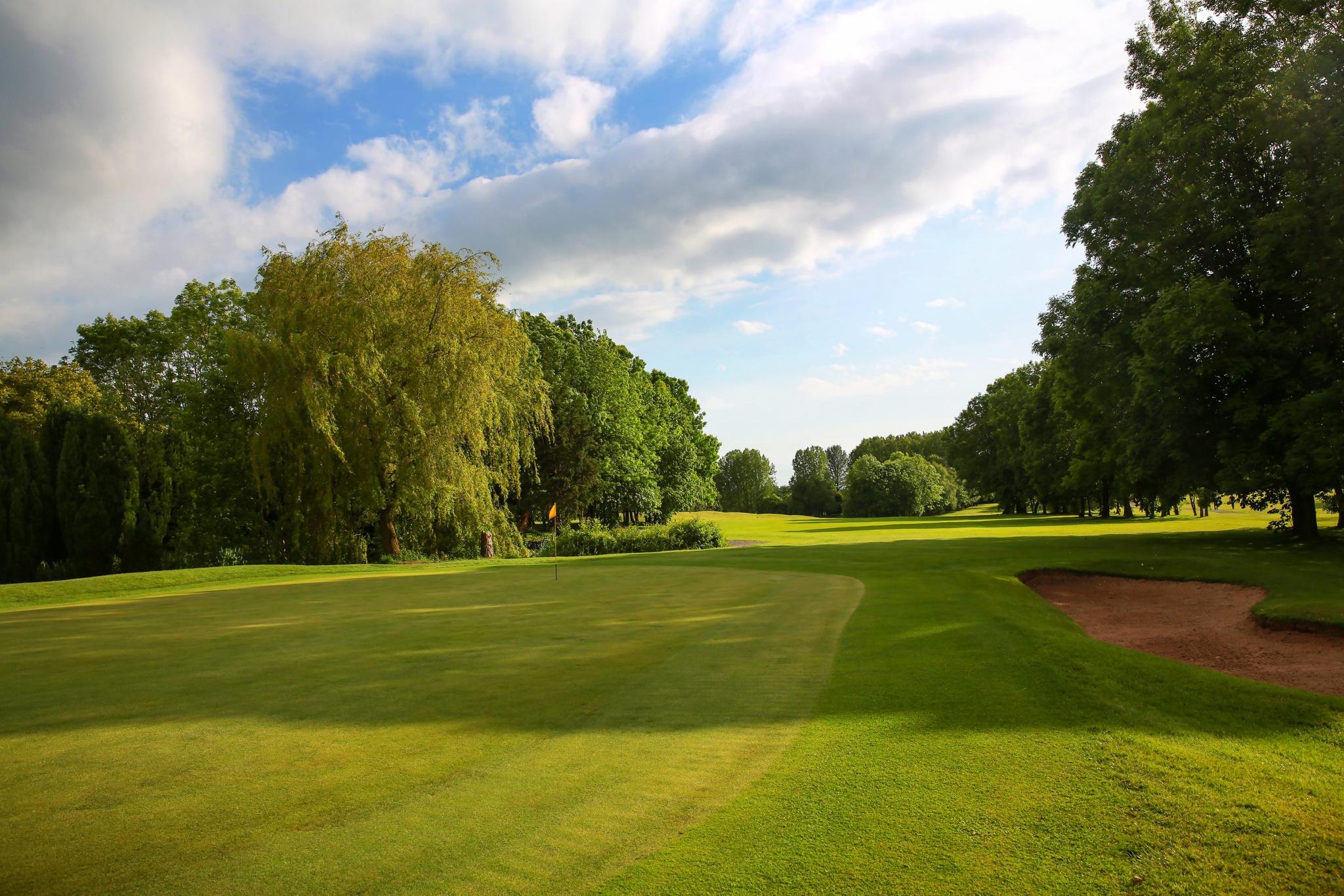 A well maintained fairway leading to a smooth green