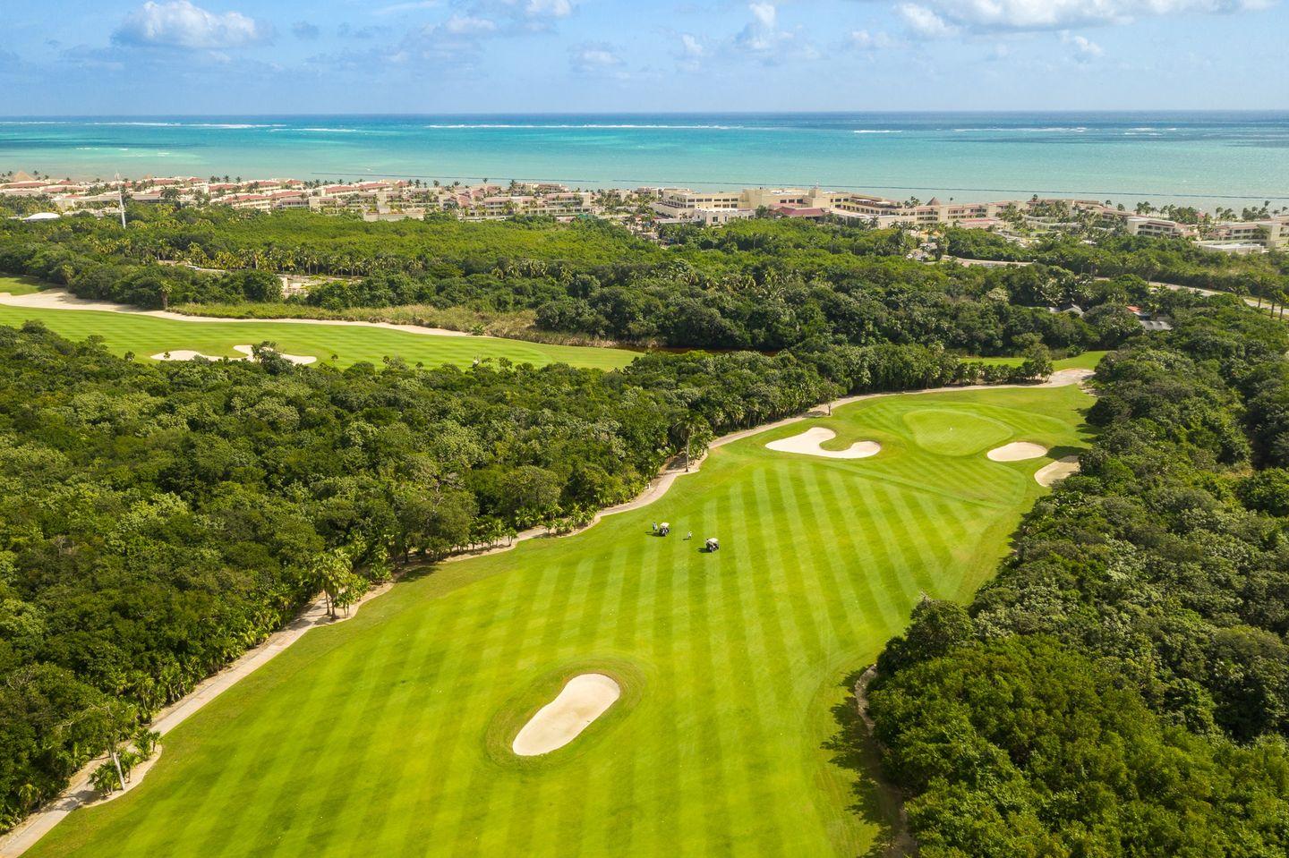 A well maintained fairway nestled with sand bunkers