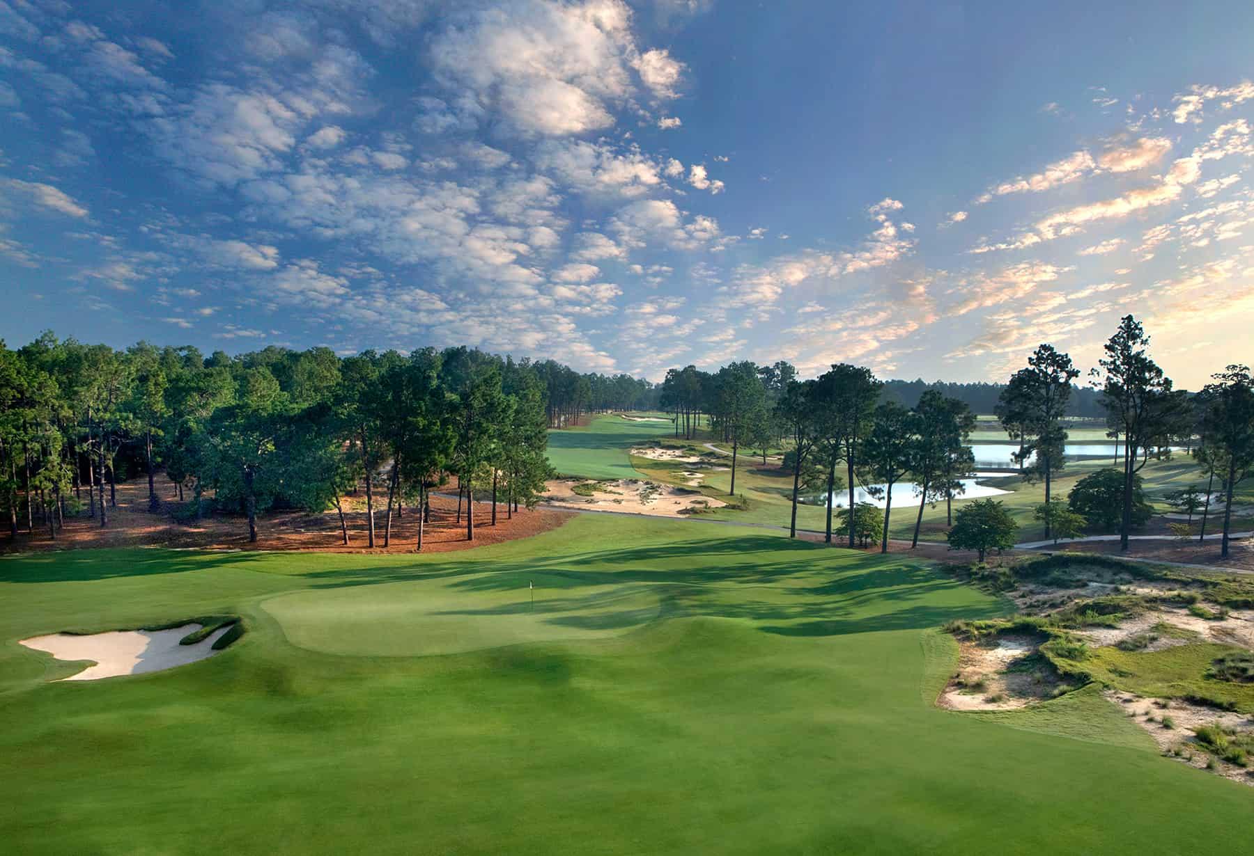 Panoramic view of a well maintained fairway nestled with sand bunkers