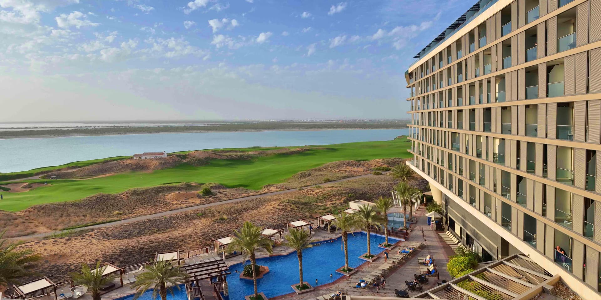 Overhead view of the outdoor swimming pool at Radisson Blu Hotel Abu Dhabi Yas Island