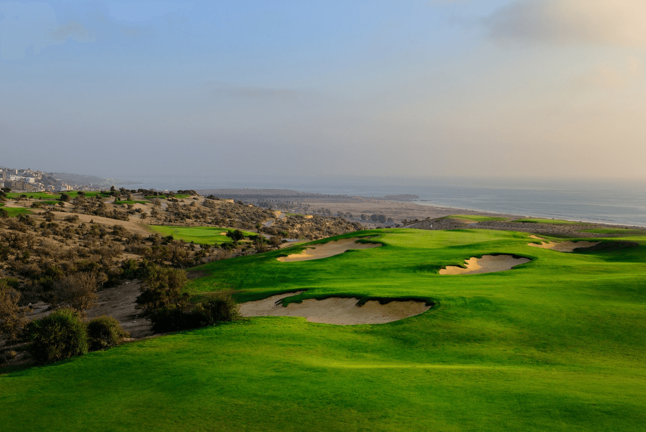 A well maintained fairway nestled with sand bunkers