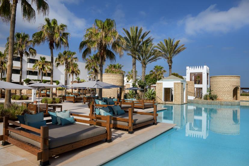 Sunbeds besides an outdoor swimming pool at Sofitel Agadir Royal Bay Resort