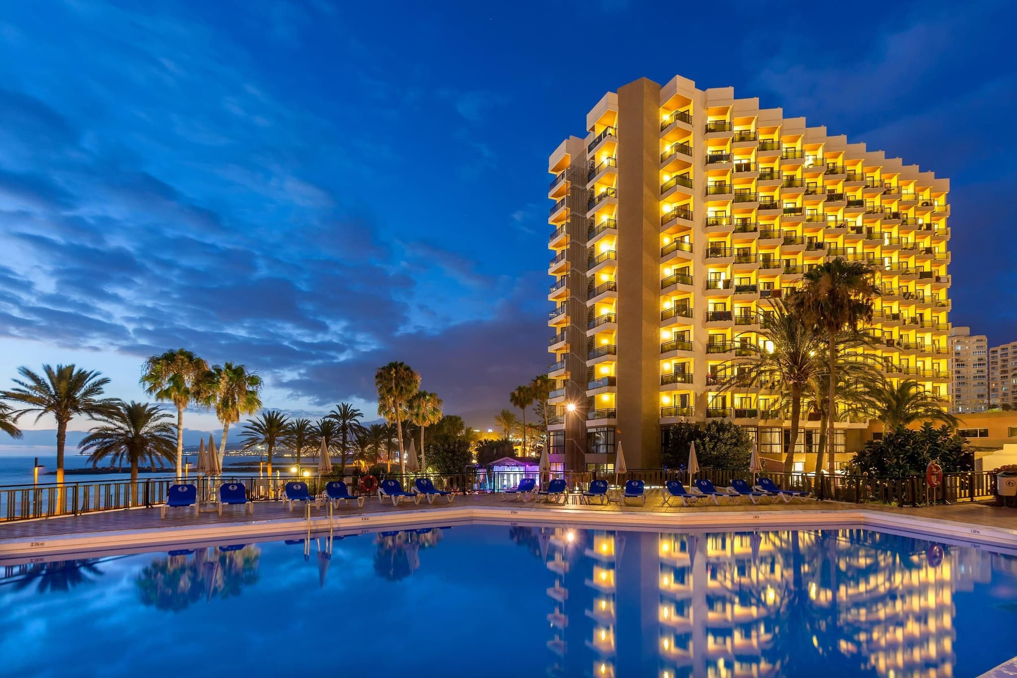 Panoramic view of the Sol Tenerife Hotel building lit up at evening