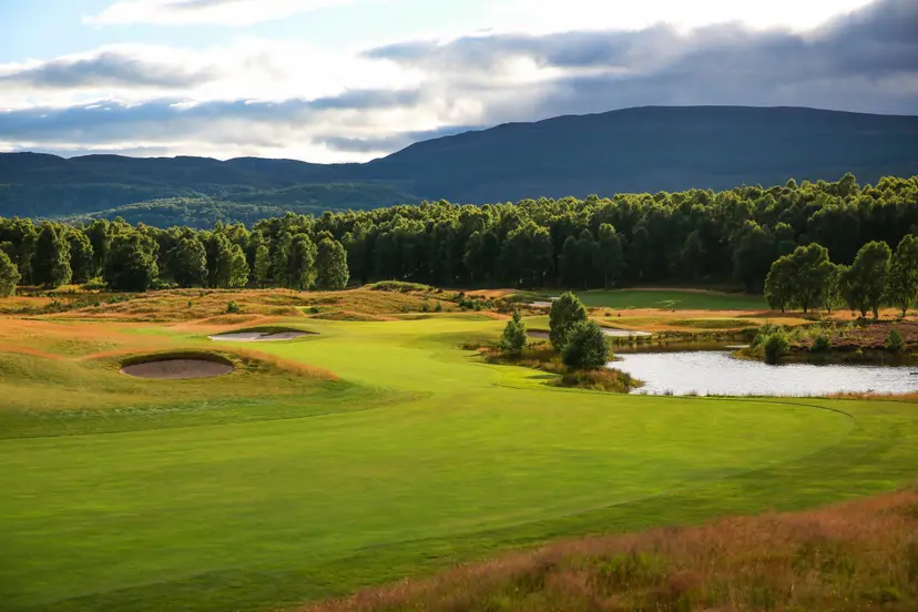 A well maintained fairway with a water hazard