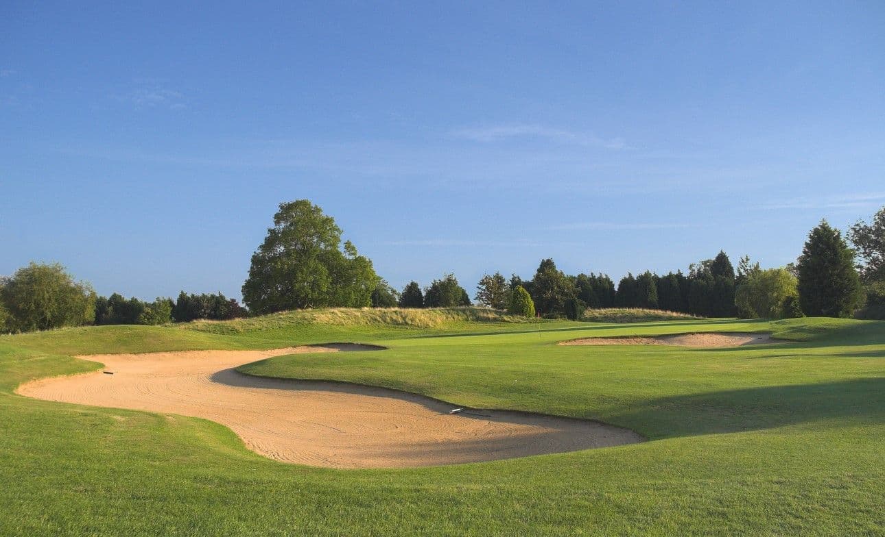 A winding fairway nestled with sand bunkers