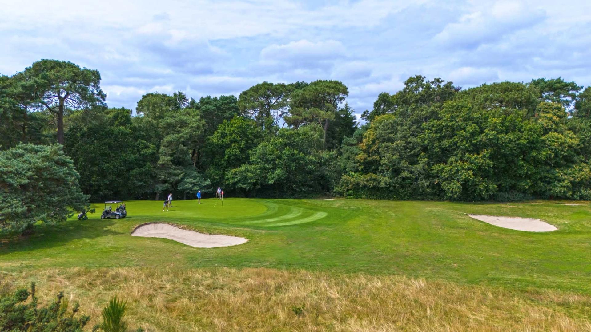 A well maintained fairway nestled with sand bunkers