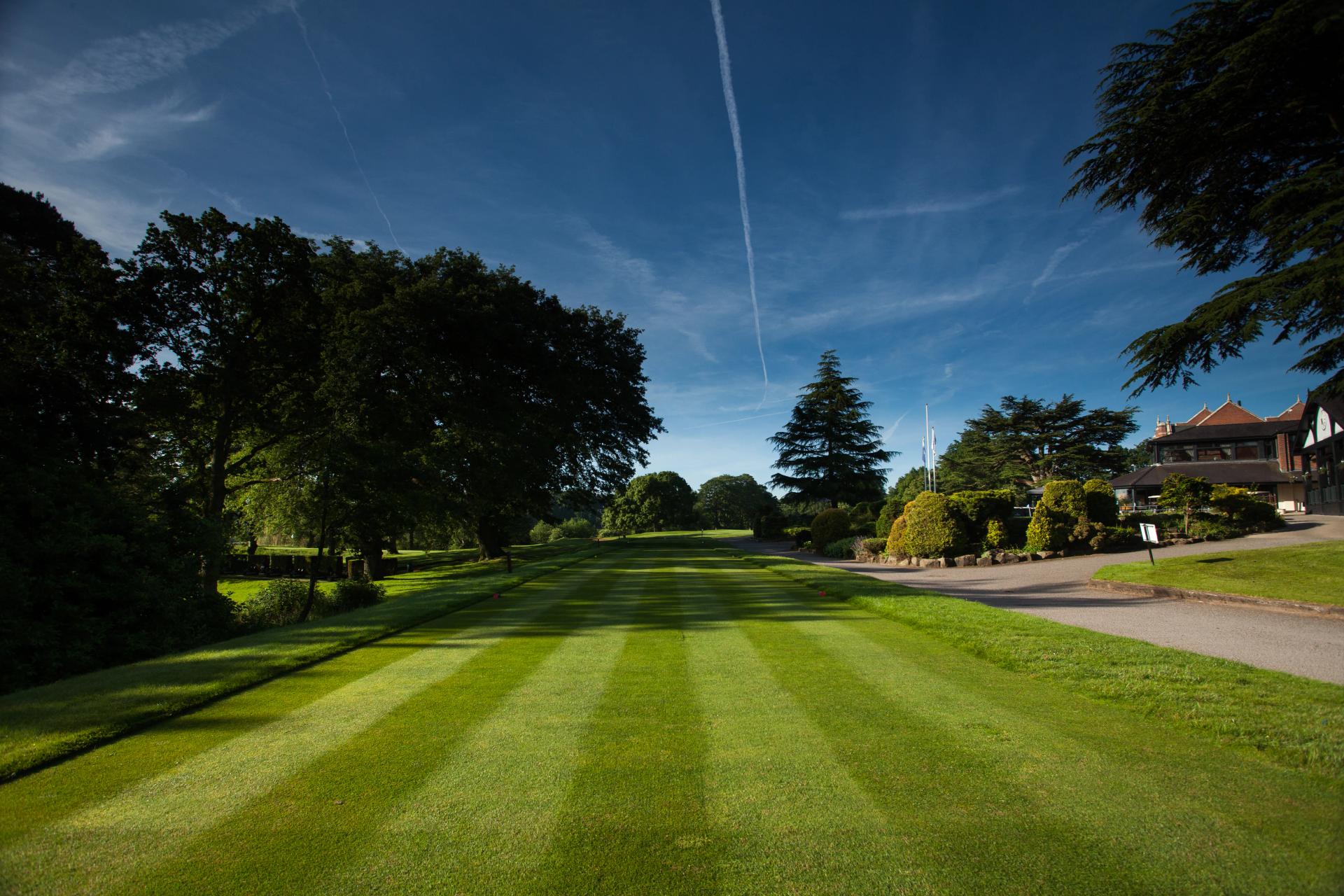 A well maintained fairway under clear blue skies