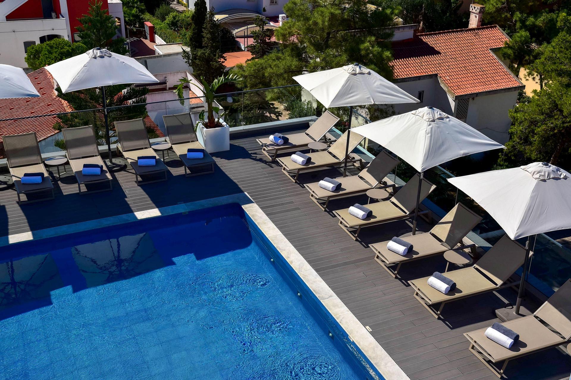 Overhead view of the rooftop swimming pool surrounded by sunbeds