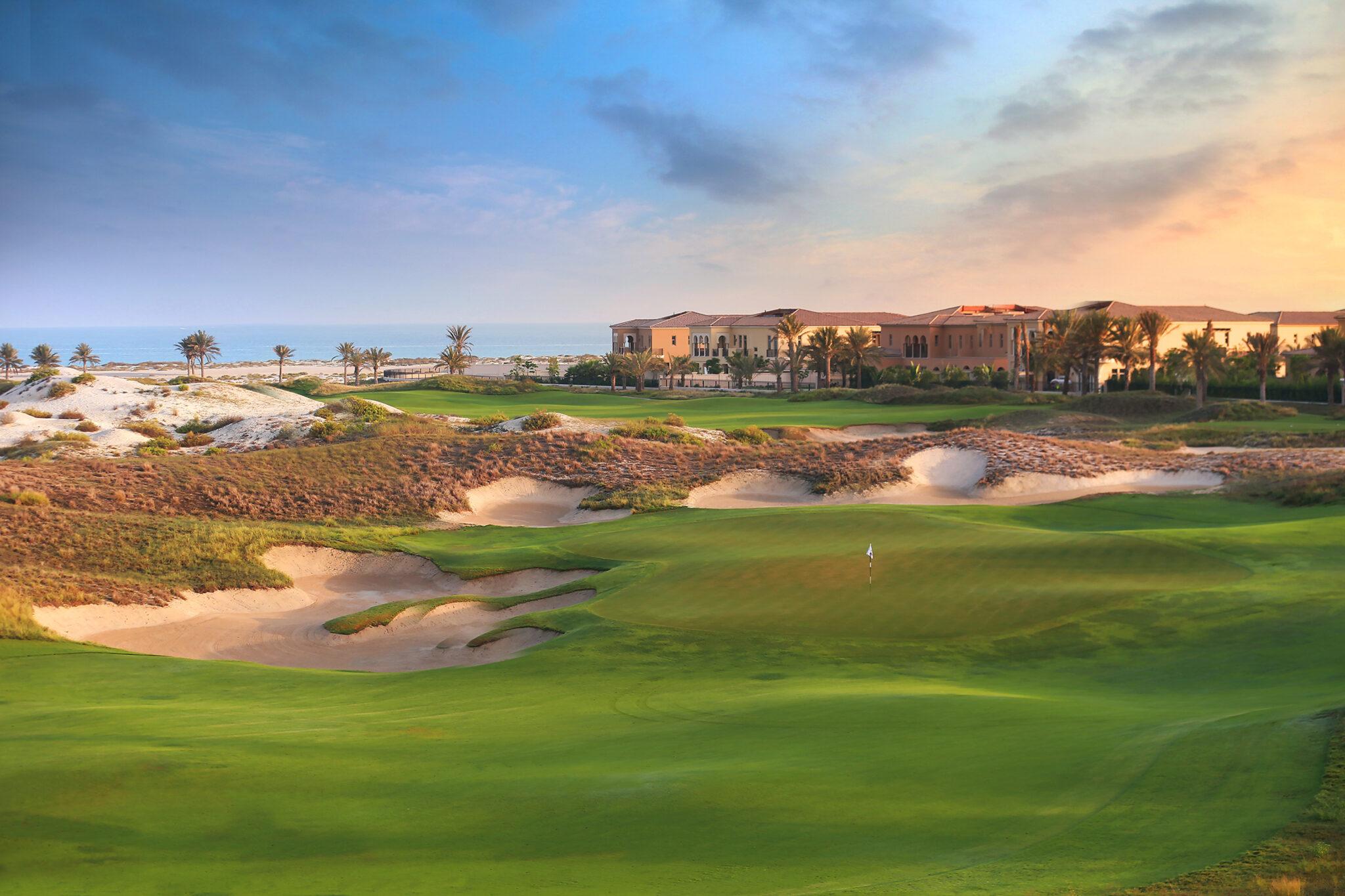 A well maintained fairway nestled with sand bunkers