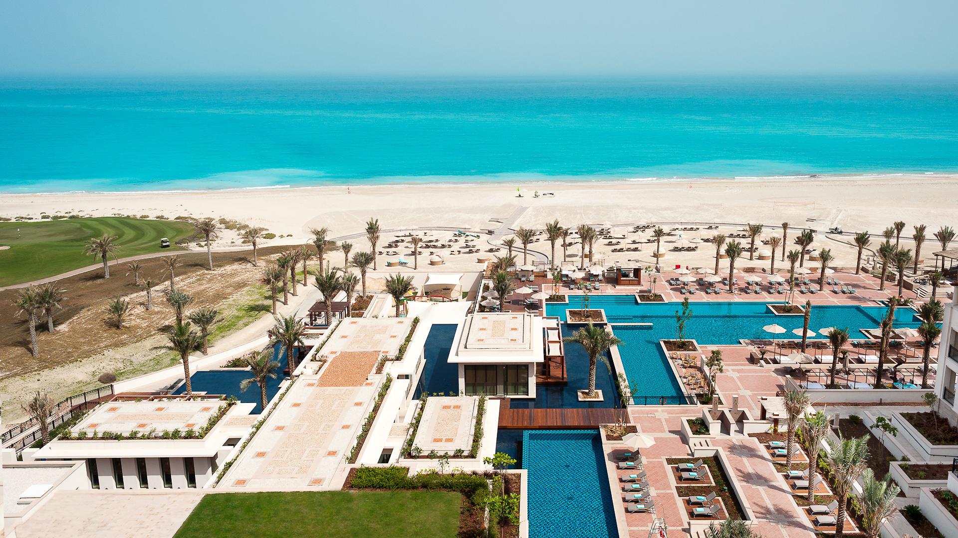 Aerial view of the outdoor swimming pool leading to the beach