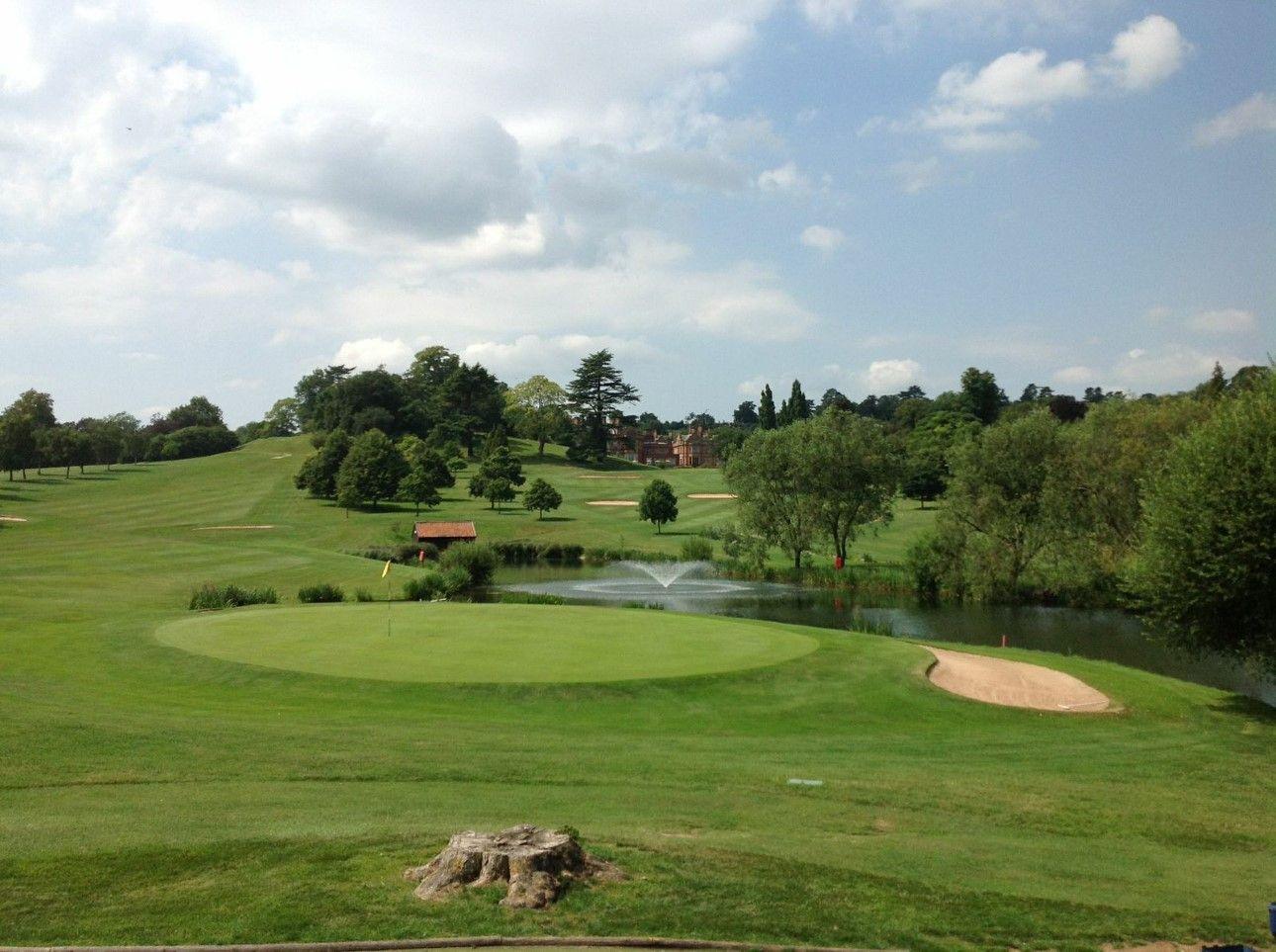 A smooth green next to a sand bunker
