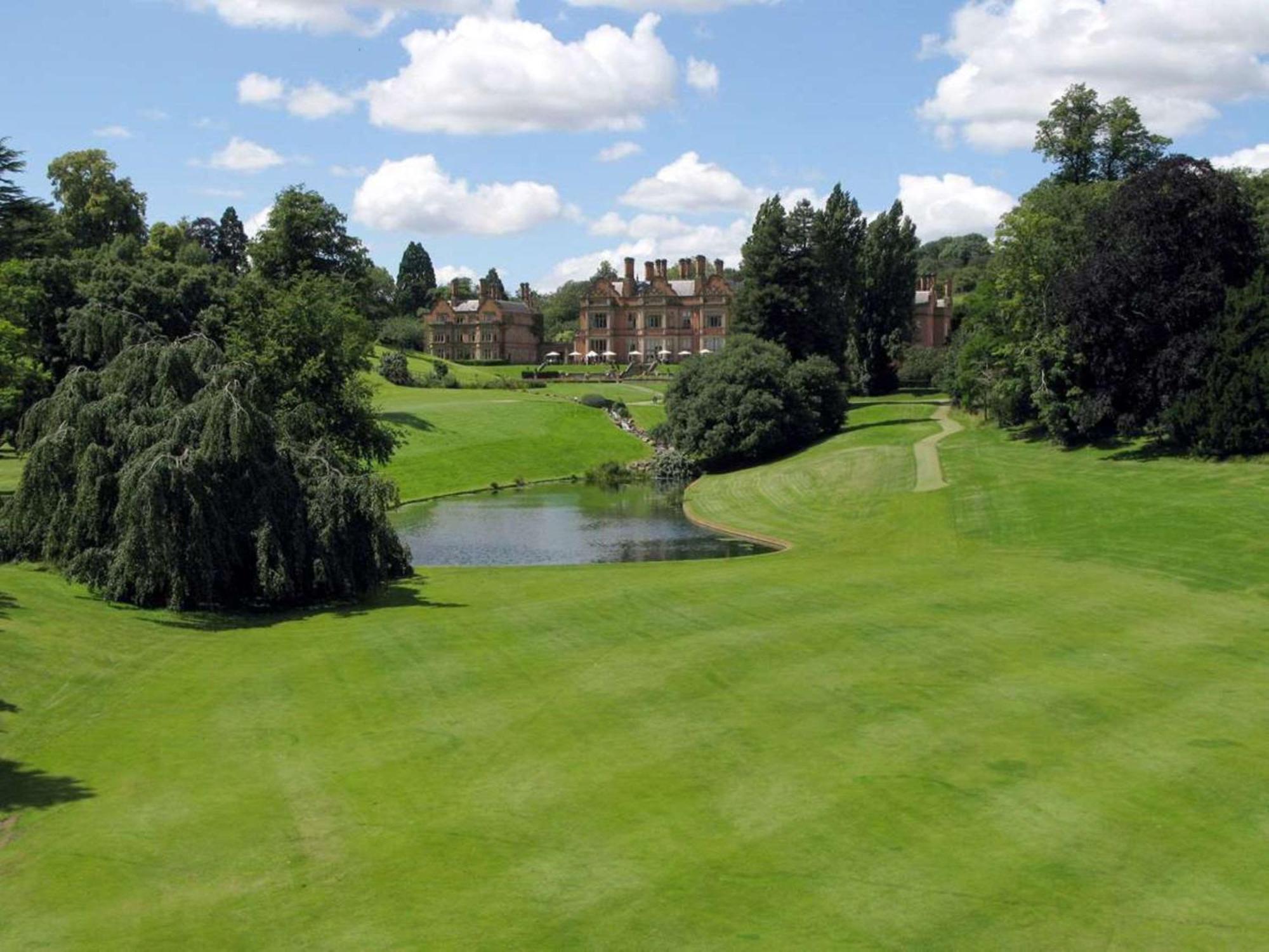 A well maintained fairway with a water hazard