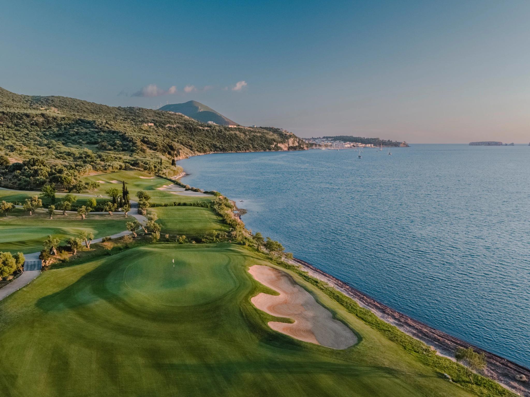 A coastal green next to a sand bunker