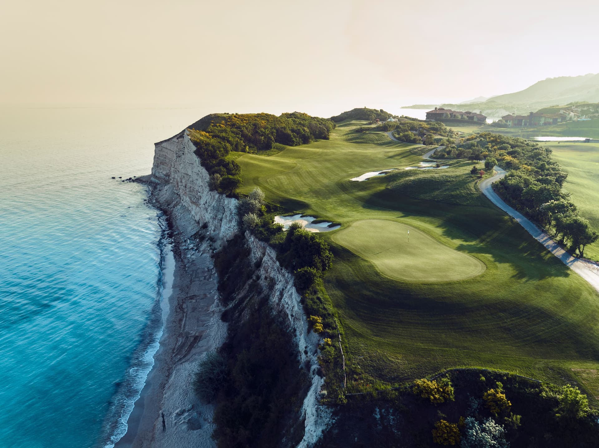 A manicured coastal fairway with sand bunkers