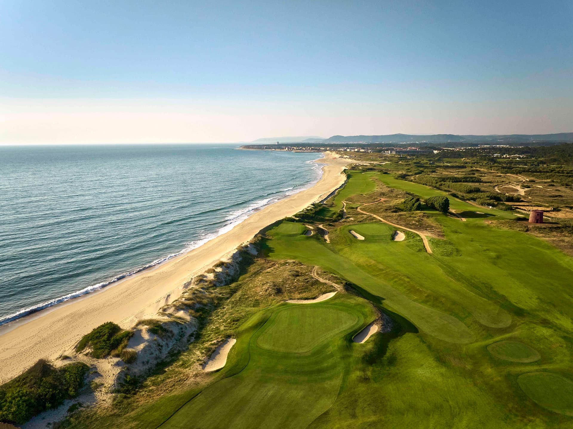 Overhead view of a coastal fairway nestles with sand bunkers at Tivoli Estela Golf & Lodges Porto