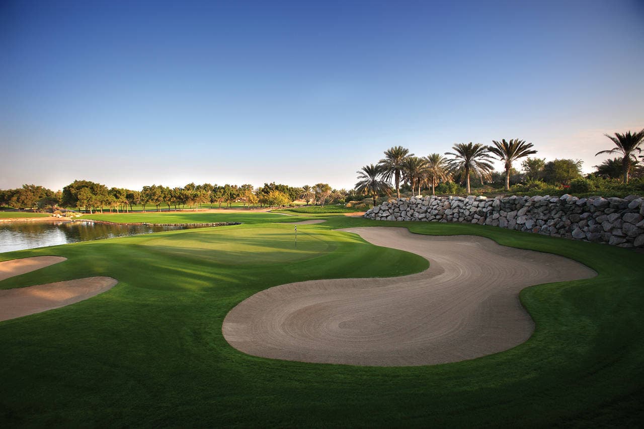 A well maintained fairway with sand bunkers