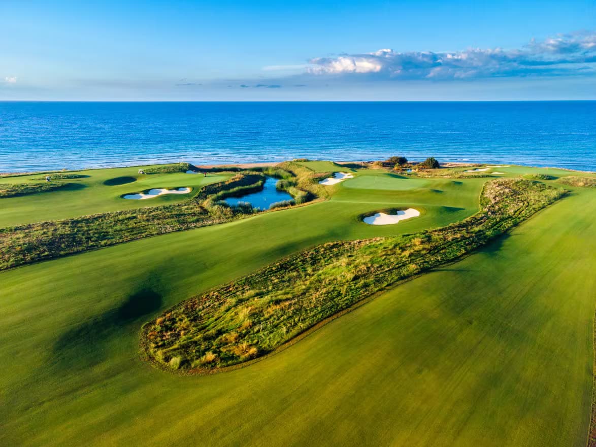 A well maintained fairway with sand bunkers