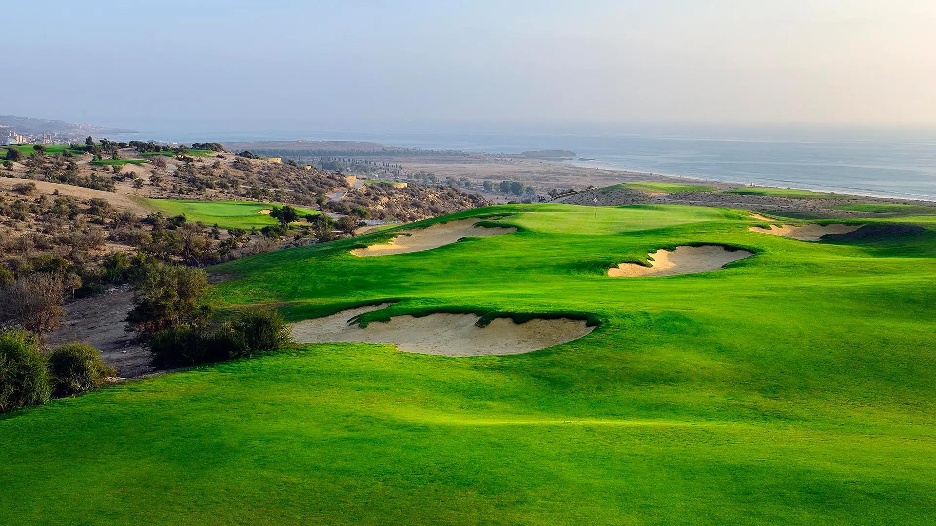 A well maintained fairway nestled with sand bunkers