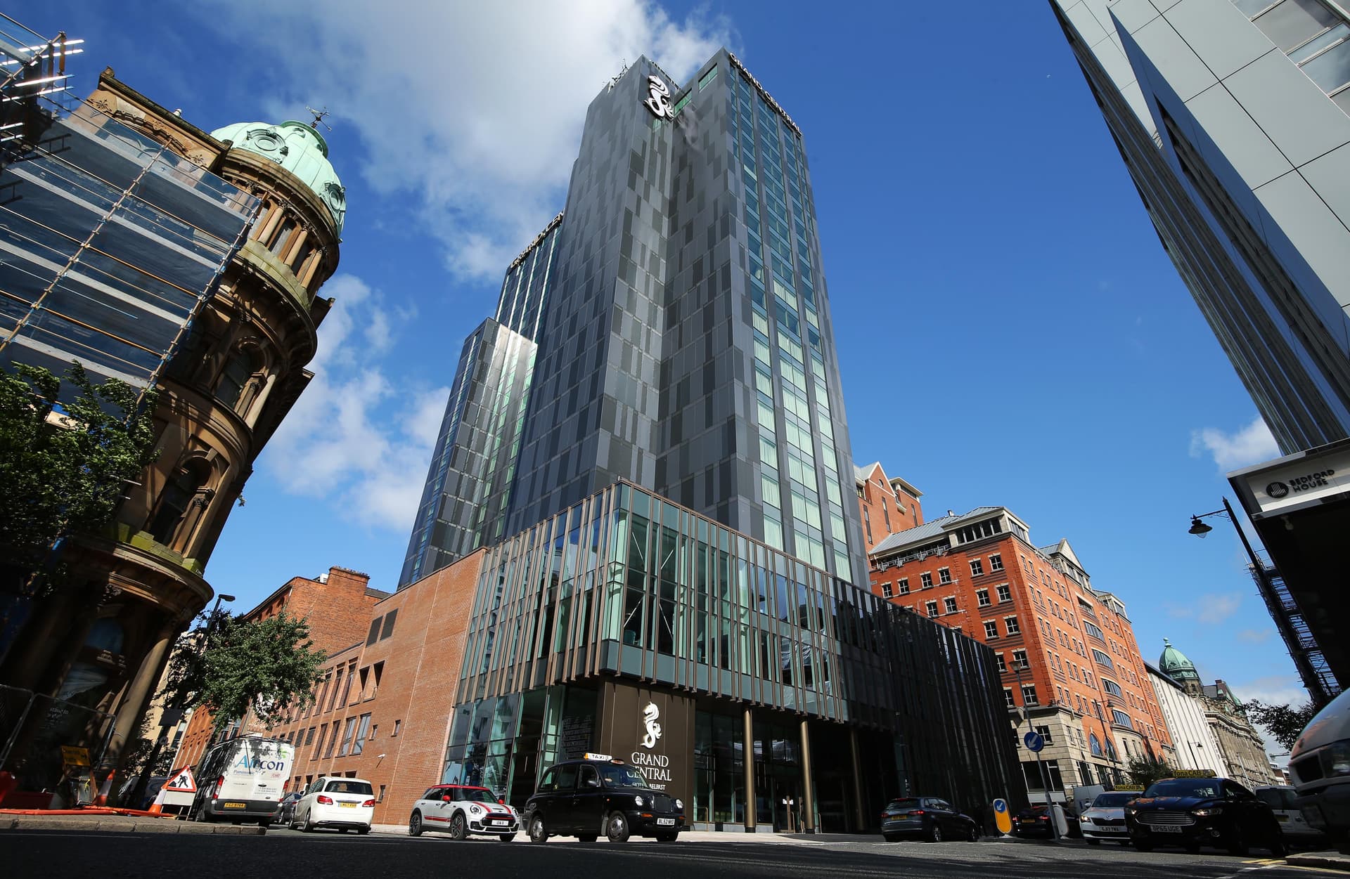 Panoramic view looking up at the Grand Central Hotel Belfast building