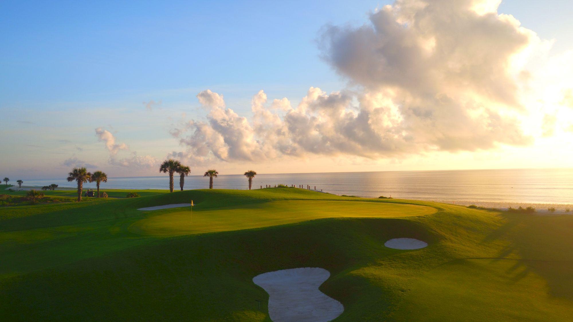 A coastal green surrounded by sand bunkers at Hammock Beach Golf Resort & Spa