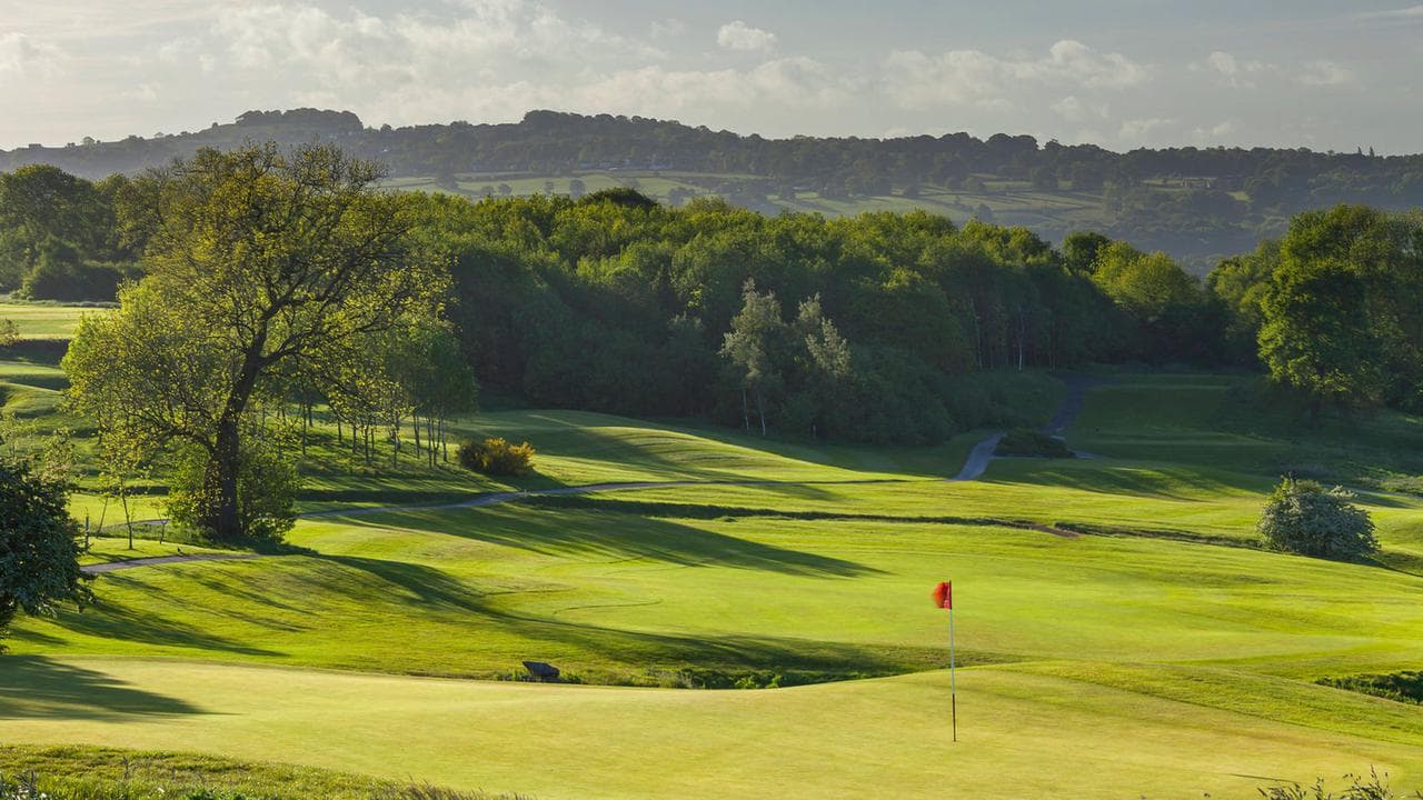Panoramic view of a well maintained fairway leading to a smooth green